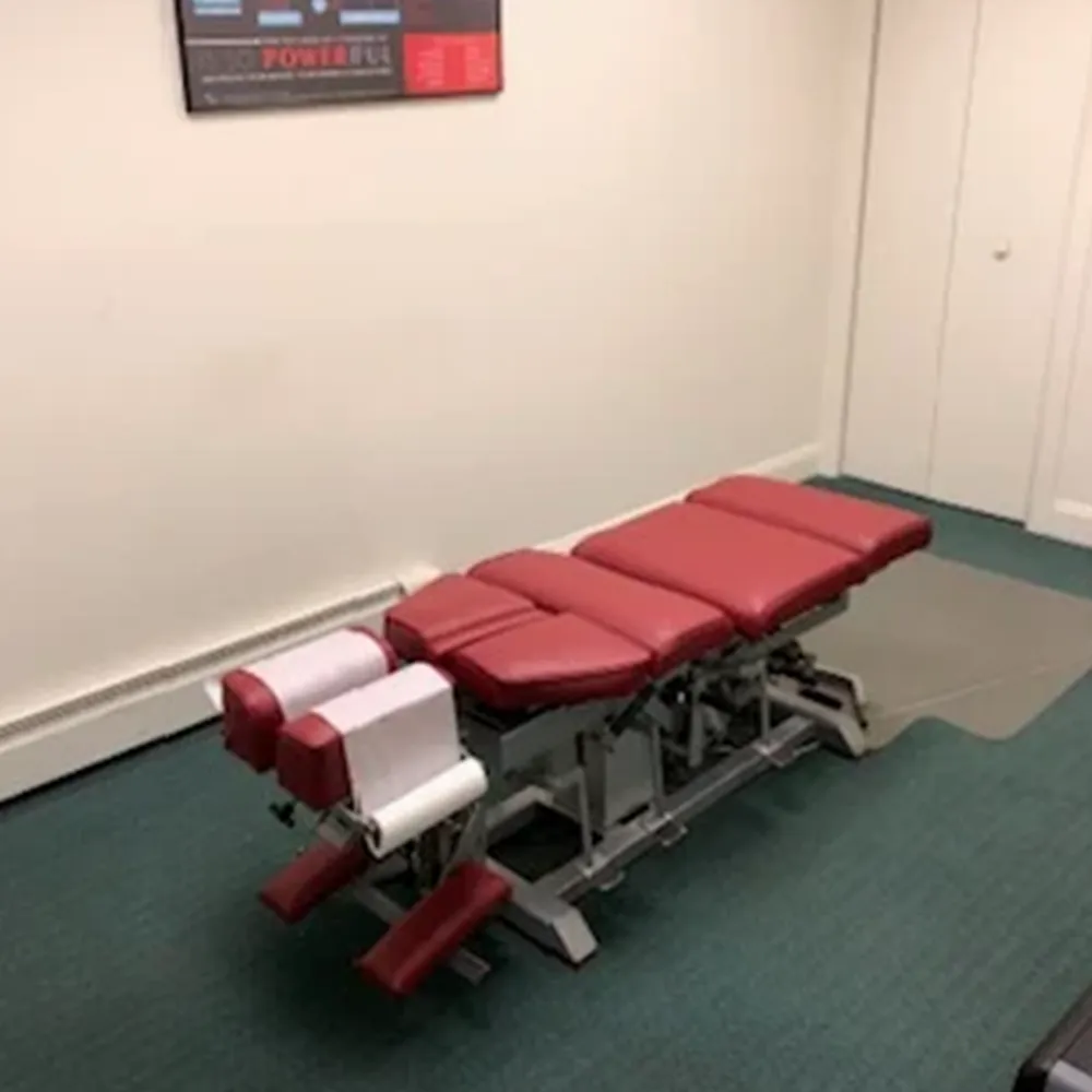 Chiropractic adjustment table with red padding