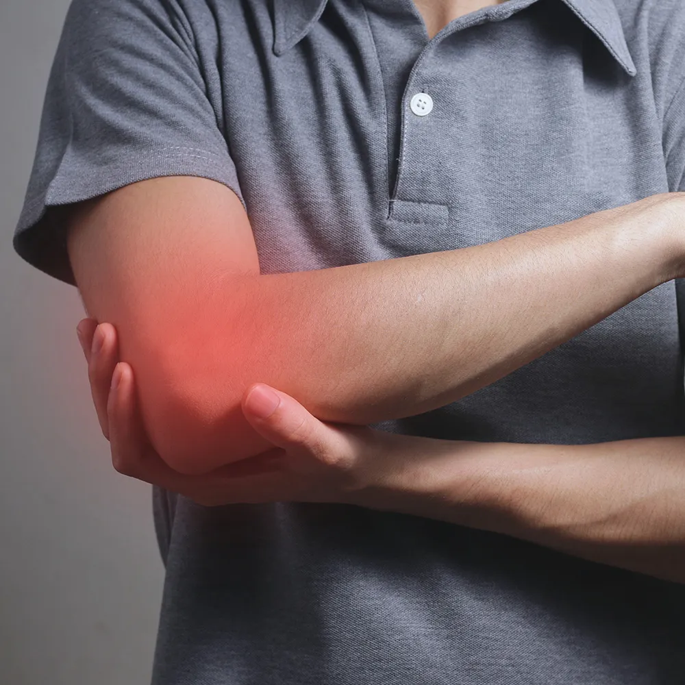 Man holding elbow in pain  