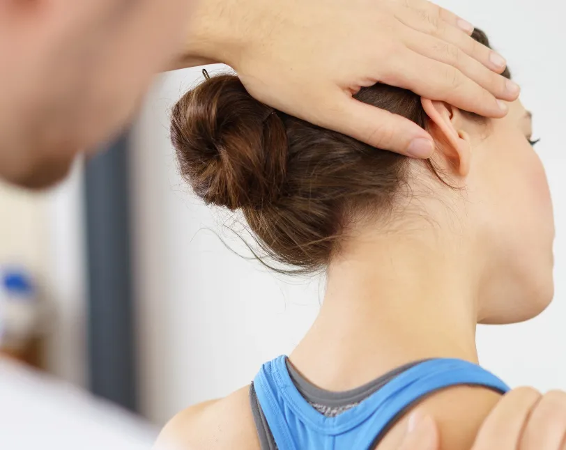 Chiropractor adjusting patient’s neck  